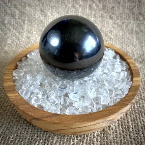 Shungite Sphere on Bed of Microtumbled Crystal in Olive Wood Bowl